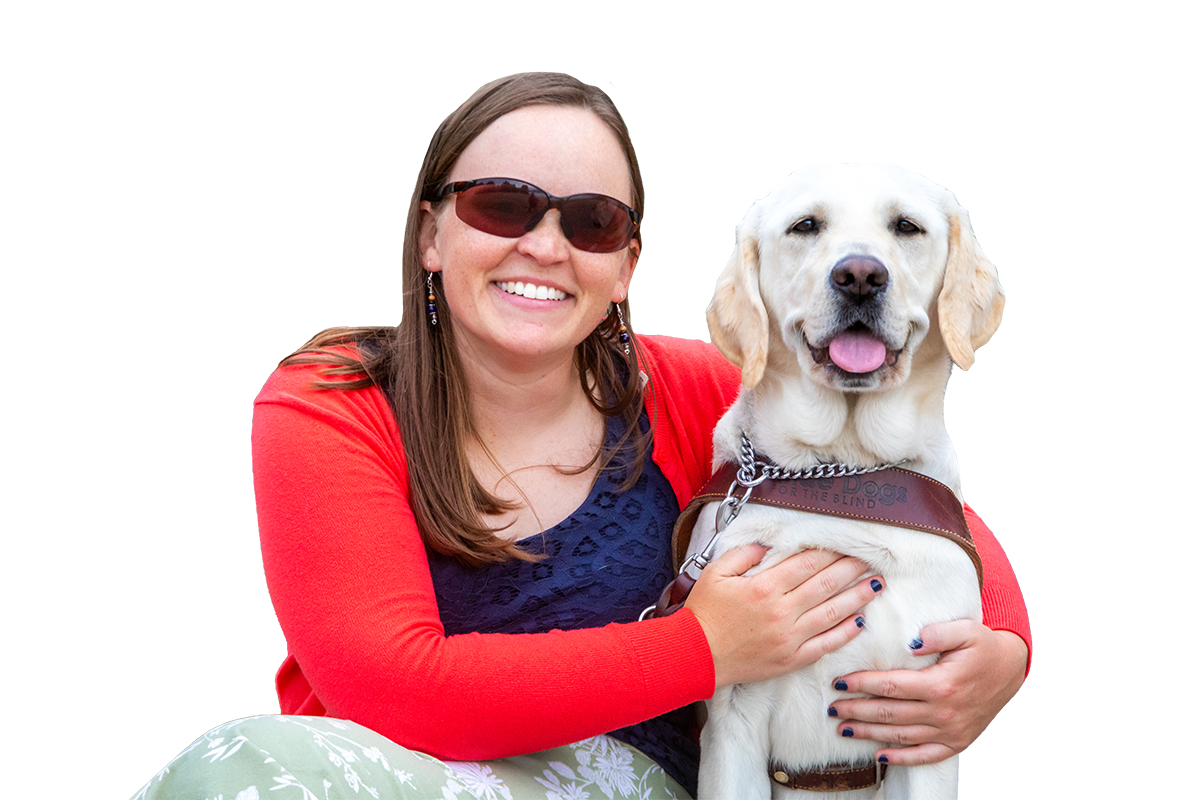 A smiling woman embraces a grinning yellow Lab guide dog.